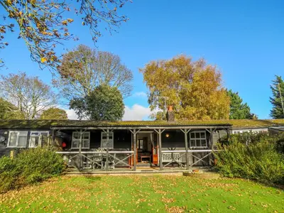 an old house with a porch in a garden at 7 The Uplands in Thorpeness