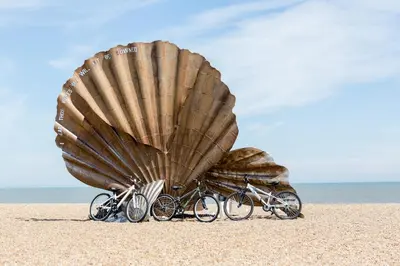 two bikes parked under a large shell on the beach at Walnut Cottage in Aldeburgh