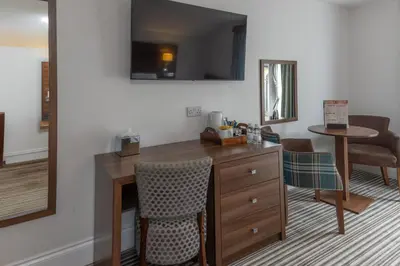 a hotel room with a desk and a mirror at Best Western Brome Grange Hotel in Brome