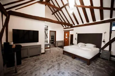 a bedroom with a bed and a flat screen tv at Best Western Brome Grange Hotel in Brome