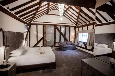 a bedroom with a large white bed and a couch at Best Western Brome Grange Hotel in Brome
