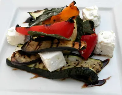 a plate of food with vegetables and cheese on it at The Anchor Ely in Ely