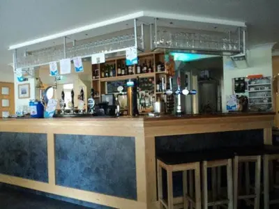 a bar with a large wooden counter top at The Anchor Ely in Ely