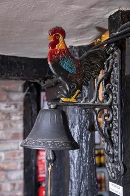a statue of a rooster on a bell at The Cock Inn Hotel in Sheering