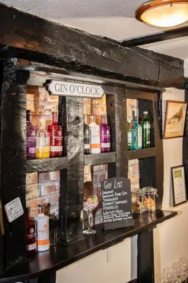 a bar made out of a wooden wall at The Cock Inn Hotel in Sheering
