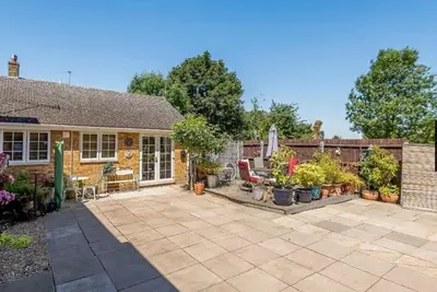 a house with a patio with plants in the yard at Little Croft in Haddenham