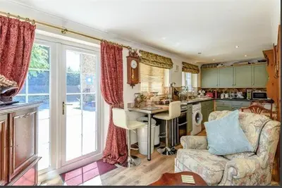 a kitchen with a couch and a table in a room at Little Croft in Haddenham