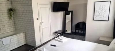 a bathroom with a sink and a mirror at The Riverside House Hotel in Mildenhall