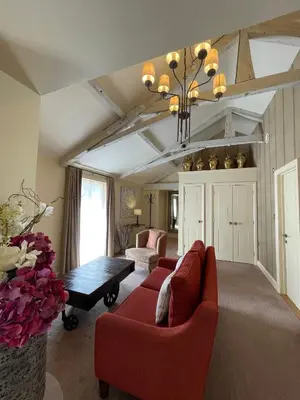 a living room with a red couch and a table at Park Farm Hotel in Norwich