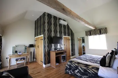 a bedroom with a bed and a tv in a room at Channels Hotel in Chelmsford