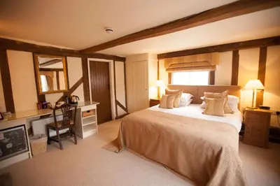 a bedroom with a large bed and a television at Channels Hotel in Chelmsford