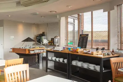 a kitchen with a counter with dishes on it at Holiday Inn Basildon by IHG in Basildon