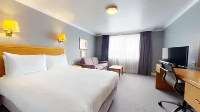 a hotel room with a bed and a television at Holiday Inn Basildon by IHG in Basildon