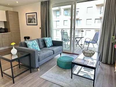 a living room with a couch and a table at Signet Apartments - Ceres in Cambridge