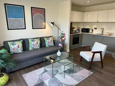 a living room with a couch and a table at Signet Apartments - Ceres in Cambridge