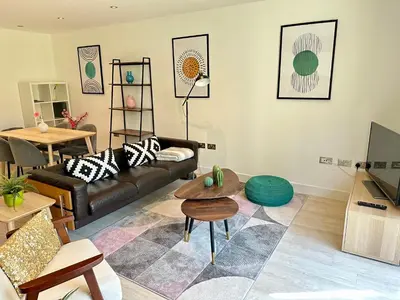 a living room with a couch and a table at Signet Apartments - Vesta in Cambridge