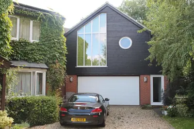 a car parked in front of a house at Pear Tree House Studio in Ely
