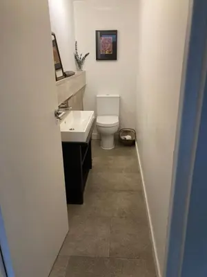 a bathroom with a white toilet and a sink at Private luxury retreat in Sible Hedingham