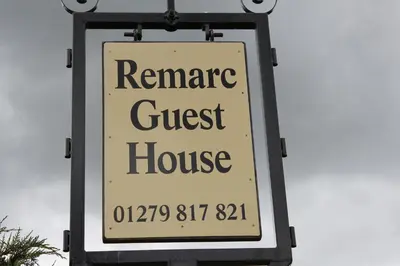 a sign for a guest house on a street at Remarc Guest House in Takeley