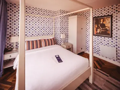 a bedroom with a white bed with aestone at The Varsity Hotel & Spa in Cambridge