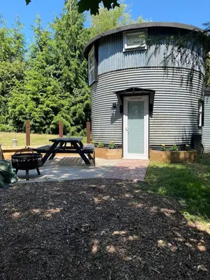 a picnic table and bench in front of a building at Cosy Camping Suffolk in Ipswich
