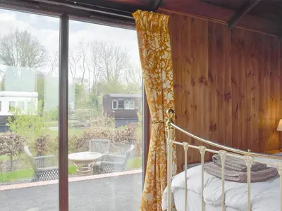 a bedroom with a canopy bed and a large window at Wilby Halt-Ukc712 in Wetheringsett