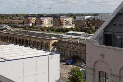 an aerial view of a city with buildings at Contemporary & Homely Penthouse, 2 mins walk from Cambridge Station, lift access, secured gated on-site parking, self check-in, SUPER Fast WIFI, Terrace & Sleeps 6 in Cambridge