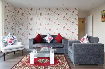 a living room with a couch and a table at Contemporary & Homely Penthouse, 2 mins walk from Cambridge Station, lift access, secured gated on-site parking, self check-in, SUPER Fast WIFI, Terrace & Sleeps 6 in Cambridge