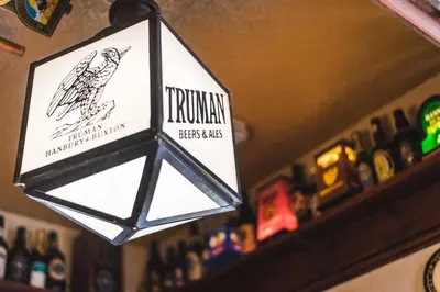a sign in a bar with a bird on it at The Red Lion in Cambridge