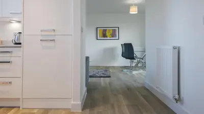 an office with white cabinets and a black chair at Tailored Stays - De Havilland House in Cambridge