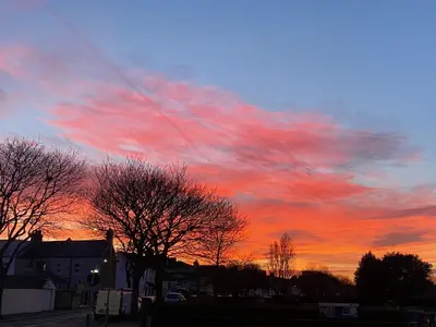 a sunset with red clouds in the sky at Pebbles Guest House in Southend-on-Sea