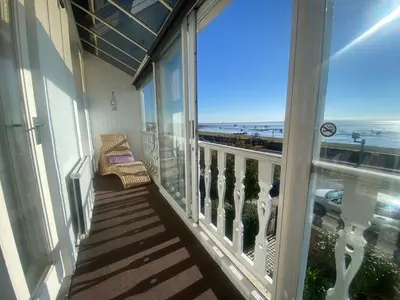 a balcony with a chair and a view of the ocean at Pebbles Guest House in Southend-on-Sea