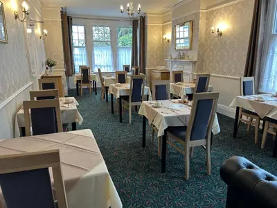 a restaurant with tables and chairs in a room at The Sandrock in Clacton-on-Sea