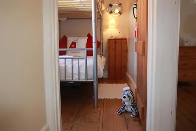 a small zebra toy is standing in a bedroom at Seaside Fisherman Cottage Aldeburgh in Aldeburgh