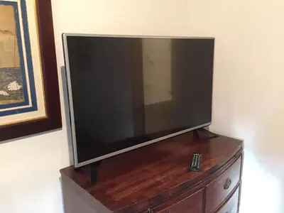 a flat screen tv sitting on top of a dresser at Cross Keys Hotel Chatteris in Chatteris