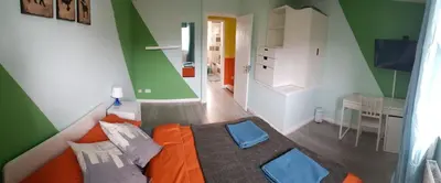 a small room with an orange bed and a desk at Columbine, Thetford, 2BR House in Thetford