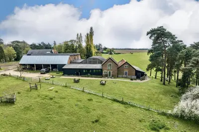 an aerial view of a farm with a barn at Lodge Farm in Freston