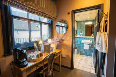 a bathroom with a desk with a sink and a toilet at Salisbury Arms Hotel in Hertford