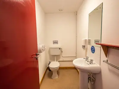 a small bathroom with a toilet and a sink at YHA London Lee Valley in Cheshunt