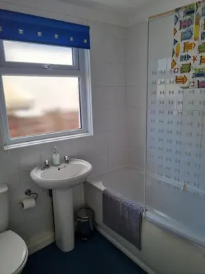 a bathroom with a sink and a toilet and a shower at Sandy Cottage in Clacton-on-Sea