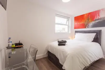 a bedroom with a white bed and a window at The Orlando in Cambridge