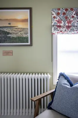 a radiator in a living room with a picture on the wall at The Bell Hotel, Saxmundham in Saxmundham