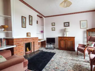 a living room with a fireplace and a tv at Glenhaven in Rendham