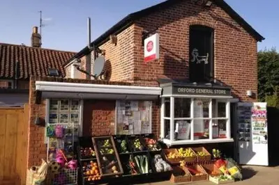 a store front of a brick building with fruits and vegetables at Crown Cottage, Orford - Prime Orford Location in Orford