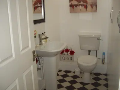 a bathroom with a white toilet and a sink at The Coach House in Shepreth