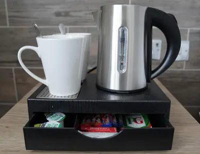 a coffee maker and a cup on a table at The New Chichester Hotel in Wickford