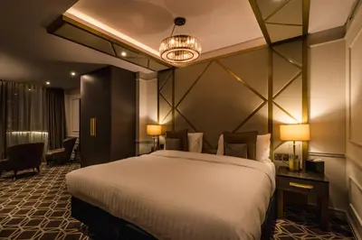 a hotel room with a large bed and a chandelier at Seven Hotel in Southend-on-Sea