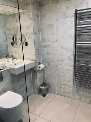 a bathroom with a toilet and a sink and a shower at Seven Hotel in Southend-on-Sea