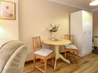 a small room with a table and two chairs at Kingfisher in Wattisfield