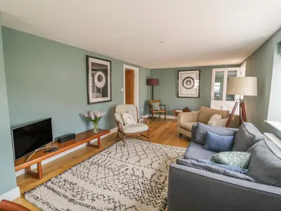 a living room with a couch and a tv at Mulberry Cottage in Hadleigh